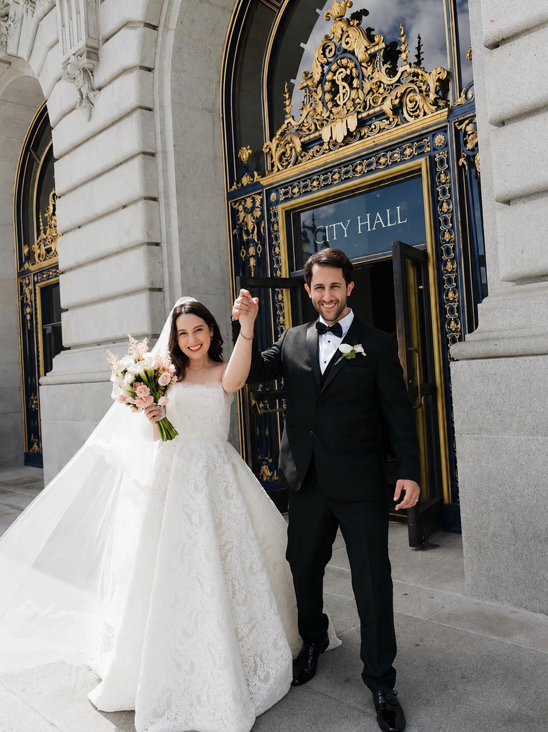 Bride and groom outside San Francisco City Hall after wedding hair and makeup by Triple Twist